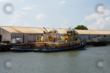 To use this stock image in your creative project, please select the size you need over to the right and click the "Add to Cart" button.
Your downloaded image will come with the Cutcaster watermark removed so don’t worry about the watermark you see on this page. Two tugboats stock photo, Two yellow, red, and black tugboats moored at a rusty dock by Lee Barnwell