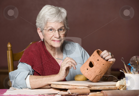 To use this stock image in your creative project, please select the size you need over to the right and click the "Add to Cart" button.
Your downloaded image will come with the Cutcaster watermark removed so don’t worry about the watermark you see on this page. Woman working with clay stock photo, Senior woman working on a clay sculpture by Scott Griessel