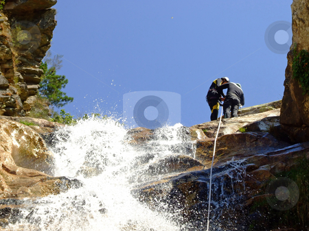 To use this stock image in your creative project, please select the size you need over to the right and click the "Add to Cart" button.
Your downloaded image will come with the Cutcaster watermark removed so don’t worry about the watermark you see on this page. Prepering for rappel stock photo, Couple prepering to descende a waterfall with roupes by Paulo Resende