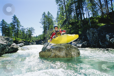 To use this stock image in your creative project, please select the size you need over to the right and click the "Add to Cart" button.
Your downloaded image will come with the Cutcaster watermark removed so don’t worry about the watermark you see on this page. Kayaker perched on boulder in river stock photo, Kayaker perched on boulder in river by Monkey Business Images