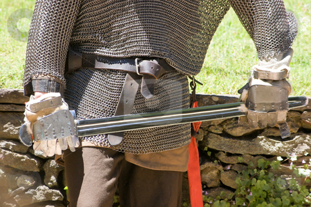 To use this stock image in your creative project, please select the size you need over to the right and click the "Add to Cart" button.
Your downloaded image will come with the Cutcaster watermark removed so don’t worry about the watermark you see on this page. Medieval Warrior stock photo, A medieval warrior in chain mail holding a sword by Nicholas Rjabow