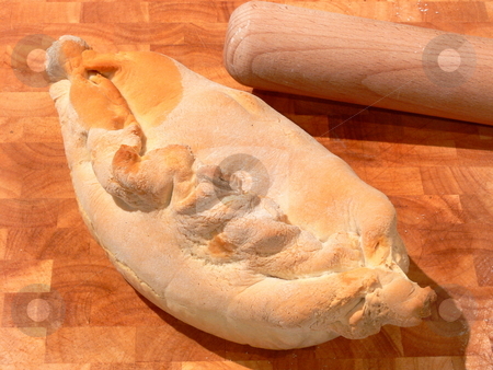 To use this stock image in your creative project, please select the size you need over to the right and click the "Add to Cart" button.
Your downloaded image will come with the Cutcaster watermark removed so don’t worry about the watermark you see on this page. Baked Good stock photo, A rustic style baked pie sits on a wooden board with a rolling pin behind. by Martin Darley