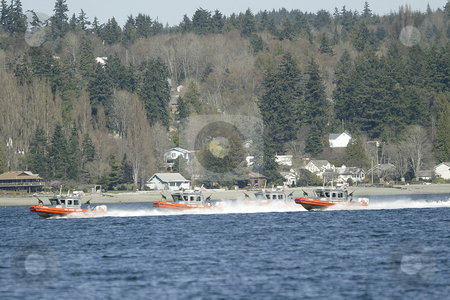 To use this stock image in your creative project, please select the size you need over to the right and click the "Add to Cart" button.
Your downloaded image will come with the Cutcaster watermark removed so don’t worry about the watermark you see on this page. The United States Coast Guard stock photo, March 3, 2004 : The United States Coast Guard ran through terrorist drills in the Sinclair Inlet waters in front of the Bremerton Navy shipyard in Bremerton, Washington. by Jesse Beals