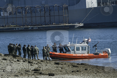To use this stock image in your creative project, please select the size you need over to the right and click the "Add to Cart" button.
Your downloaded image will come with the Cutcaster watermark removed so don’t worry about the watermark you see on this page. The United States Coast Guard stock photo, March 3, 2004 : The United States Coast Guard ran through terrorist drills in the Sinclair Inlet waters in front of the Bremerton Navy shipyard in Bremerton, Washington. by Jesse Beals
