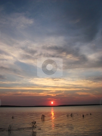 To use this stock image in your creative project, please select the size you need over to the right and click the "Add to Cart" button.
Your downloaded image will come with the Cutcaster watermark removed so don’t worry about the watermark you see on this page. Sunrise Over Lake - Orman Dam stock photo, Taken At A Near By Lake Close To My Home Town Of Belle Fourche South Dakota by Brian Meyer