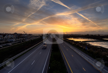 To use this stock image in your creative project, please select the size you need over to the right and click the "Add to Cart" button.
Your downloaded image will come with the Cutcaster watermark removed so don’t worry about the watermark you see on this page. High road stock photo, Highway in the sunset by Paulo Resende