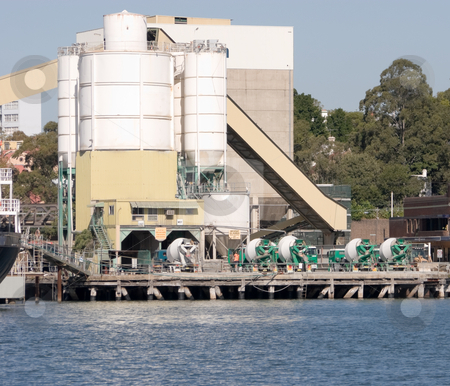 To use this stock image in your creative project, please select the size you need over to the right and click the "Add to Cart" button.
Your downloaded image will come with the Cutcaster watermark removed so don’t worry about the watermark you see on this page. Cement Trucks and Silos stock photo, A cement depot on the water by Nicholas Rjabow