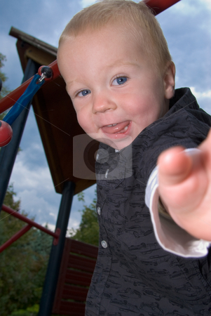 To use this stock image in your creative project, please select the size you need over to the right and click the "Add to Cart" button.
Your downloaded image will come with the Cutcaster watermark removed so don’t worry about the watermark you see on this page. Cheeky boy stock photo, A little boy standing on the playground looking cheeky into the camera by Alexander L?