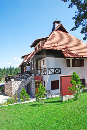 To use this stock image in your creative project, please select the size you need over to the right and click the "Add to Cart" button.
Your downloaded image will come with the Cutcaster watermark removed so don’t worry about the watermark you see on this page. Cottage tiled roof stock photo, Weekend house with garden in Serbia, Zlatibor by Julija Sapic