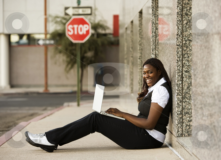 To use this stock image in your creative project, please select the size you need over to the right and click the "Add to Cart" button.
Your downloaded image will come with the Cutcaster watermark removed so don’t worry about the watermark you see on this page. African American Woman with Laptop stock photo, Pretty African American woman on sidealk with laptop computer by Scott Griessel