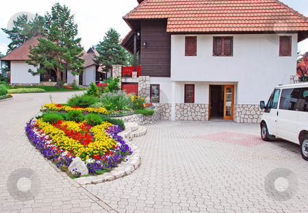 To use this stock image in your creative project, please select the size you need over to the right and click the "Add to Cart" button.
Your downloaded image will come with the Cutcaster watermark removed so don’t worry about the watermark you see on this page. Cottage village stock photo, Weekend houses with gardens and stone road in Serbia, Zlatibor by Julija Sapic