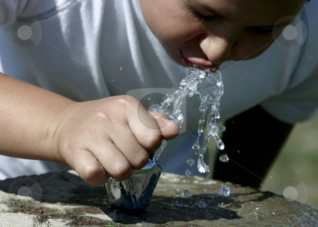 To use this stock image in your creative project, please select the size you need over to the right and click the "Add to Cart" button.
Your downloaded image will come with the Cutcaster watermark removed so don’t worry about the watermark you see on this page. Thirsty stock photo, Boy drinking from a water fountain. by Nikki Rose
