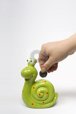 To use this stock image in your creative project, please select the size you need over to the right and click the "Add to Cart" button.
Your downloaded image will come with the Cutcaster watermark removed so don’t worry about the watermark you see on this page. Snail Saving stock photo, A female hand deposits a coin into a green snail shaped savings box by Steve Smith