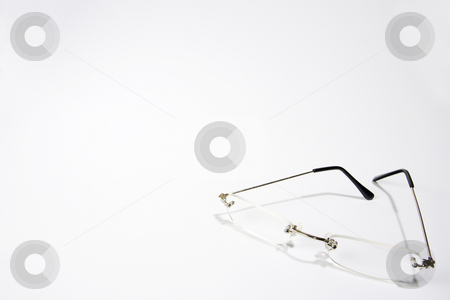 To use this stock image in your creative project, please select the size you need over to the right and click the "Add to Cart" button.
Your downloaded image will come with the Cutcaster watermark removed so don’t worry about the watermark you see on this page. Reading Glasses stock photo, A pair of reading glasses partially folded on the lower right-hand side of a white frame by Steve Smith