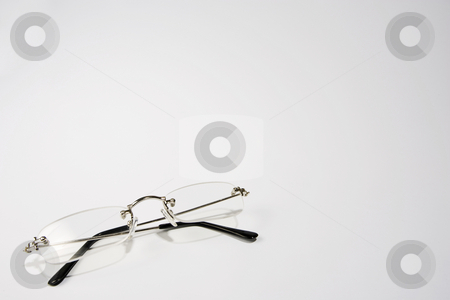 To use this stock image in your creative project, please select the size you need over to the right and click the "Add to Cart" button.
Your downloaded image will come with the Cutcaster watermark removed so don’t worry about the watermark you see on this page. Reading Glasses stock photo, A pair of reading glasses folded on the lower left-hand side of a white frame by Steve Smith