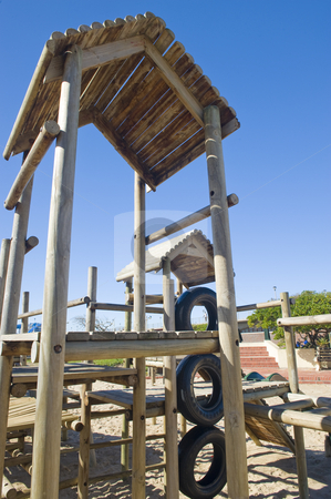 To use this stock image in your creative project, please select the size you need over to the right and click the "Add to Cart" button.
Your downloaded image will come with the Cutcaster watermark removed so don’t worry about the watermark you see on this page. Park with jungle jim stock photo, A park next to the beach with a play area for kids containing a wooden jungle-jim. by Nicolaas Traut