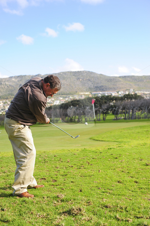 To use this stock image in your creative project, please select the size you need over to the right and click the "Add to Cart" button.
Your downloaded image will come with the Cutcaster watermark removed so don’t worry about the watermark you see on this page. Senior golfer in action stock photo, An elderly retired golfer in action on a practice range, hitting the ball with a club. by Nicolaas Traut