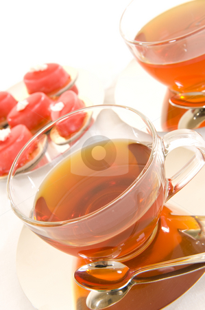 To use this stock image in your creative project, please select the size you need over to the right and click the "Add to Cart" button.
Your downloaded image will come with the Cutcaster watermark removed so don’t worry about the watermark you see on this page. Tea and confectionery stock photo, Freshly brewed red tea in a glass cup on a shiny saucer, with some colorful confectionery on a white background. by Nicolaas Traut