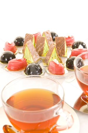 To use this stock image in your creative project, please select the size you need over to the right and click the "Add to Cart" button.
Your downloaded image will come with the Cutcaster watermark removed so don’t worry about the watermark you see on this page. Tea and confectionery stock photo, Freshly brewed red tea in a glass cup on a shiny saucer, with some colorful confectionery on a white background. by Nicolaas Traut