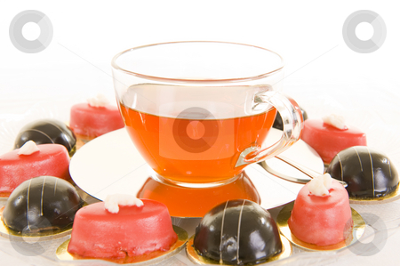 To use this stock image in your creative project, please select the size you need over to the right and click the "Add to Cart" button.
Your downloaded image will come with the Cutcaster watermark removed so don’t worry about the watermark you see on this page. Tea and confectionery stock photo, Freshly brewed red tea in a glass cup on a shiny saucer, with some colorful confectionery on a white background. by Nicolaas Traut