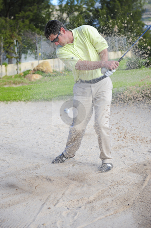 To use this stock image in your creative project, please select the size you need over to the right and click the "Add to Cart" button.
Your downloaded image will come with the Cutcaster watermark removed so don’t worry about the watermark you see on this page. Golfer playing out of a sand trap stock photo, A professional golfer playing a shot out of a sand-trap with excellent control. by Nicolaas Traut