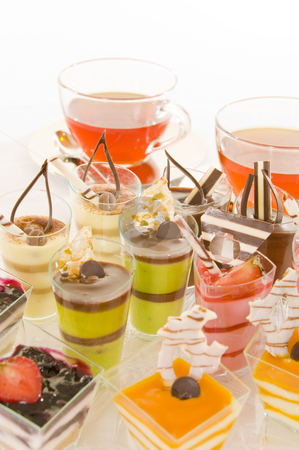 To use this stock image in your creative project, please select the size you need over to the right and click the "Add to Cart" button.
Your downloaded image will come with the Cutcaster watermark removed so don’t worry about the watermark you see on this page. Tea and confectionery stock photo, Freshly brewed red tea in a glass cup on a shiny saucer, with some colorful confectionery on a white background. by Nicolaas Traut