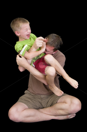 To use this stock image in your creative project, please select the size you need over to the right and click the "Add to Cart" button.
Your downloaded image will come with the Cutcaster watermark removed so don’t worry about the watermark you see on this page. Adorable young family playing stock photo, An adorable young family playing and having fun. Studio shot isolated on black. by Nicolaas Traut