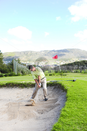 To use this stock image in your creative project, please select the size you need over to the right and click the "Add to Cart" button.
Your downloaded image will come with the Cutcaster watermark removed so don’t worry about the watermark you see on this page. Golfer playing out of a sand trap stock photo, A professional golfer playing a shot out of a sand-trap with excellent control. by Nicolaas Traut