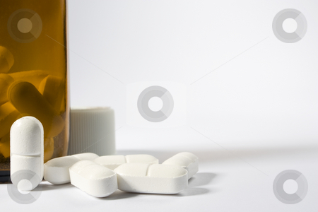 To use this stock image in your creative project, please select the size you need over to the right and click the "Add to Cart" button.
Your downloaded image will come with the Cutcaster watermark removed so don’t worry about the watermark you see on this page. Pills and bottle stock photo, A group of pills on the lower left-hand side of a white frame with one standing up nest to a brown bottle by Steve Smith