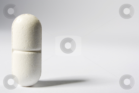 To use this stock image in your creative project, please select the size you need over to the right and click the "Add to Cart" button.
Your downloaded image will come with the Cutcaster watermark removed so don’t worry about the watermark you see on this page. Pill stock photo, A single pill standing up on the left-hand side of a white frame by Steve Smith
