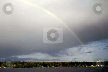 To use this stock image in your creative project, please select the size you need over to the right and click the "Add to Cart" button.
Your downloaded image will come with the Cutcaster watermark removed so don’t worry about the watermark you see on this page. Rainbow stock photo, October 9, 2003 : A rainbow could be seen peaking through the rain storm clouds over head in Dyes Inlet in Silverdale, Washington. by Jesse Beals