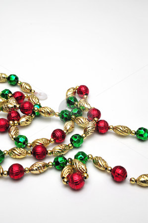 To use this stock image in your creative project, please select the size you need over to the right and click the "Add to Cart" button.
Your downloaded image will come with the Cutcaster watermark removed so don’t worry about the watermark you see on this page. Christmas Bead Decoration stock photo, A strand of decorative beads for a christmas tree by Lynn Bendickson