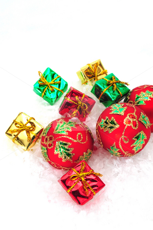 To use this stock image in your creative project, please select the size you need over to the right and click the "Add to Cart" button.
Your downloaded image will come with the Cutcaster watermark removed so don’t worry about the watermark you see on this page. Small Gifts And Ornaments stock photo, Red christmas tree ornaments and small colorful gifts by Lynn Bendickson