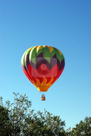 To use this stock image in your creative project, please select the size you need over to the right and click the "Add to Cart" button.
Your downloaded image will come with the Cutcaster watermark removed so don’t worry about the watermark you see on this page. Hot Air Ballon And Clear Sky stock photo, A multi colored Hot Ait Ballon rises into a clear bright sky by Lynn Bendickson