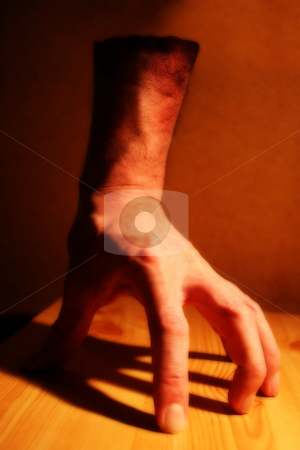 To use this stock image in your creative project, please select the size you need over to the right and click the "Add to Cart" button.
Your downloaded image will come with the Cutcaster watermark removed so don’t worry about the watermark you see on this page. Fantasy Hand stock photo, An effects image of a disembodied hand under tungsten lighting on a wooden board with a heavy shadow. Intentionally semi-blurred. by Steve Smith