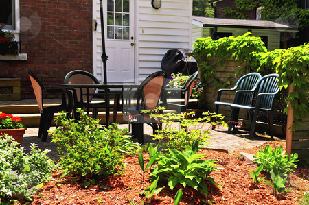 To use this stock image in your creative project, please select the size you need over to the right and click the "Add to Cart" button.
Your downloaded image will come with the Cutcaster watermark removed so don’t worry about the watermark you see on this page. House patio stock photo, House patio with outdoor furniture and garden by Elena Elisseeva