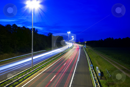 To use this stock image in your creative project, please select the size you need over to the right and click the "Add to Cart" button.
Your downloaded image will come with the Cutcaster watermark removed so don’t worry about the watermark you see on this page. Night highway stock photo, Highway at night with rays of light passing by by Karin Claus