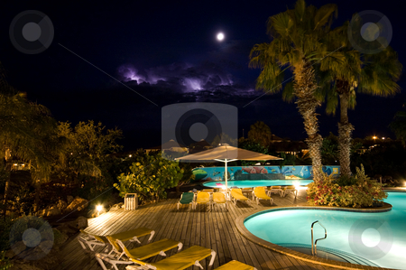To use this stock image in your creative project, please select the size you need over to the right and click the "Add to Cart" button.
Your downloaded image will come with the Cutcaster watermark removed so don’t worry about the watermark you see on this page. Night pool stock photo, Swimmingpool at night with thunder in the back by Karin Claus