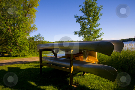 To use this stock image in your creative project, please select the size you need over to the right and click the "Add to Cart" button.
Your downloaded image will come with the Cutcaster watermark removed so don’t worry about the watermark you see on this page. Canoes Resting by Lake stock photo, Canoes and kayaks on a platform resting by a lakeside. by John McLaird