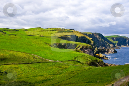 To use this stock image in your creative project, please select the size you need over to the right and click the "Add to Cart" button.
Your downloaded image will come with the Cutcaster watermark removed so don’t worry about the watermark you see on this page. Dangrous cliffs stock photo, Dangerous coastal cliffs covered with grass and rain clouds in the back by Karin Claus