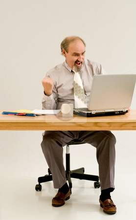 To use this stock image in your creative project, please select the size you need over to the right and click the "Add to Cart" button.
Your downloaded image will come with the Cutcaster watermark removed so don’t worry about the watermark you see on this page. Businessman likes what he sees on laptop. stock photo, Businessman seated at a desk with laptop and files. by RCarner Photography