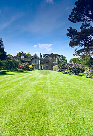 To use this stock image in your creative project, please select the size you need over to the right and click the "Add to Cart" button.
Your downloaded image will come with the Cutcaster watermark removed so don’t worry about the watermark you see on this page. Tudor Garden stock photo, A beautiful garden with lush lawns leading to a Tudor house. by Norma Cornes