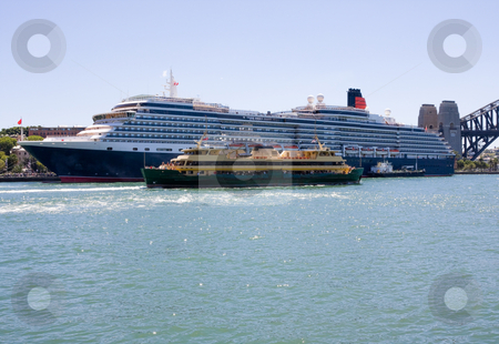 To use this stock image in your creative project, please select the size you need over to the right and click the "Add to Cart" button.
Your downloaded image will come with the Cutcaster watermark removed so don’t worry about the watermark you see on this page. Ferry and Cruise Ship stock photo, A ferry dwarfed by a cruise ship by Nicholas Rjabow