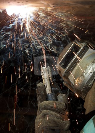 To use this stock image in your creative project, please select the size you need over to the right and click the "Add to Cart" button.
Your downloaded image will come with the Cutcaster watermark removed so don’t worry about the watermark you see on this page. Hot handed stock photo, A welder working at shipyard under vessel by Glen Jones