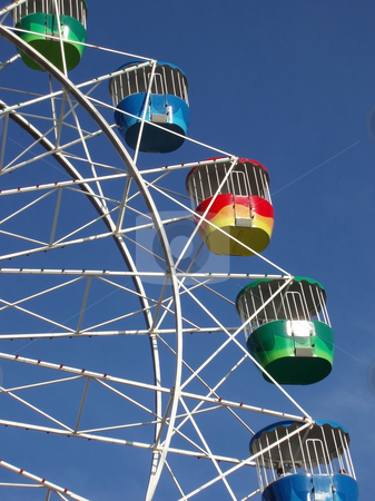 To use this stock image in your creative project, please select the size you need over to the right and click the "Add to Cart" button.
Your downloaded image will come with the Cutcaster watermark removed so don’t worry about the watermark you see on this page. Ferris wheel stock photo, A colourful fairground wheel against a blue sky by Stephen Gibson