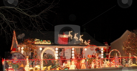 To use this stock image in your creative project, please select the size you need over to the right and click the "Add to Cart" button.
Your downloaded image will come with the Cutcaster watermark removed so don’t worry about the watermark you see on this page. Christmas Decoration Overload stock photo, House is decorated to the max in the yard and on the house. by Janie Mertz