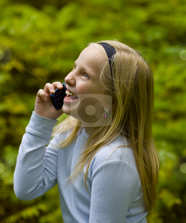 To use this stock image in your creative project, please select the size you need over to the right and click the "Add to Cart" button.
Your downloaded image will come with the Cutcaster watermark removed so don’t worry about the watermark you see on this page. Happy Girl on Phone stock photo, A happy girl on a cell phone outdoors by John McLaird