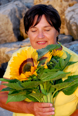 To use this stock image in your creative project, please select the size you need over to the right and click the "Add to Cart" button.
Your downloaded image will come with the Cutcaster watermark removed so don’t worry about the watermark you see on this page. Mature woman flowers stock photo, Mature woman with bouquet of sunflowers by Elena Elisseeva
