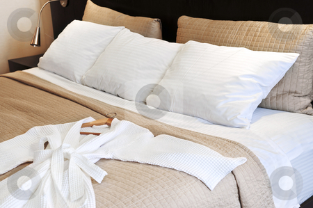 To use this stock image in your creative project, please select the size you need over to the right and click the "Add to Cart" button.
Your downloaded image will come with the Cutcaster watermark removed so don’t worry about the watermark you see on this page. Hotel bed with bathrobe stock photo, Comfortable bed with clean bathrobe in upscale hotel by Elena Elisseeva