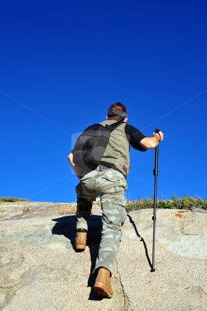 To use this stock image in your creative project, please select the size you need over to the right and click the "Add to Cart" button.
Your downloaded image will come with the Cutcaster watermark removed so don’t worry about the watermark you see on this page. Reaching The Summit stock photo, A single male day hiker reaches the summit of a granite mountain to by Lynn Bendickson